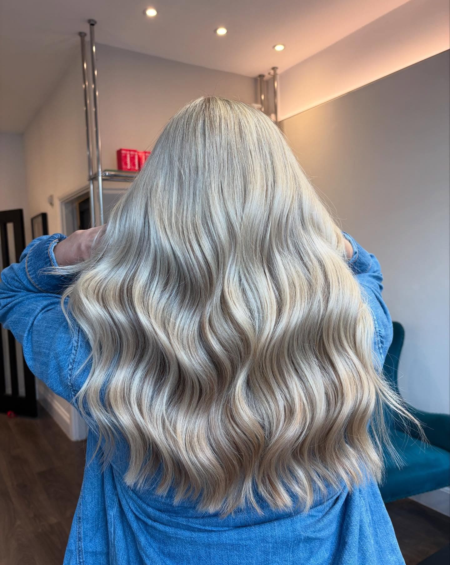 Platinum blonde waves photographed from behind after a full head of highlights