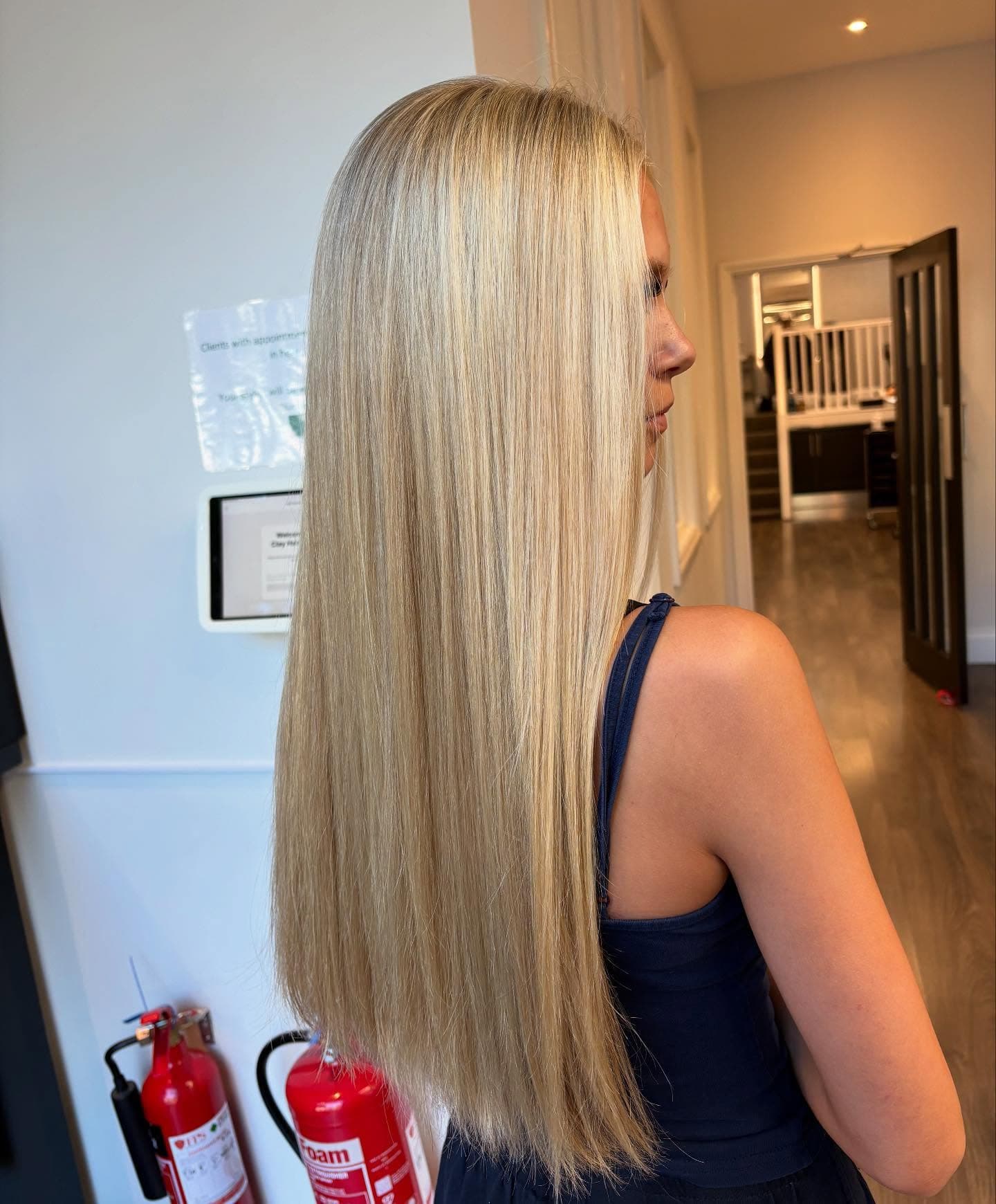 Long hair cut and finished poker straight, photographed from behind