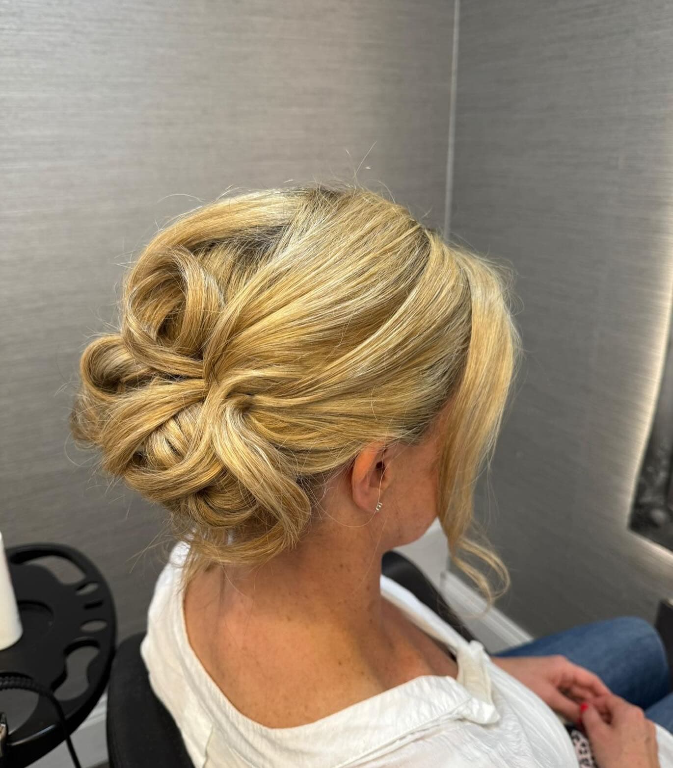 A soft blonde occasion up-do, pinned and photographed from behind