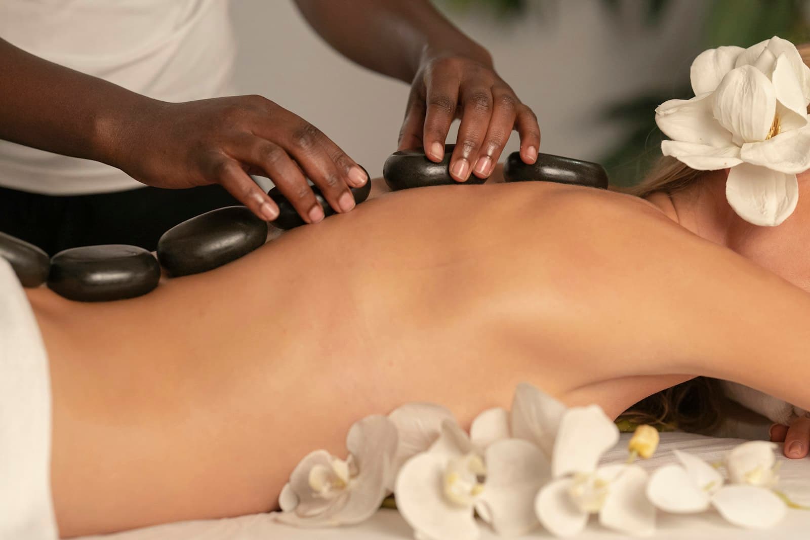 A spa treatment in progress, warm stones and soft light