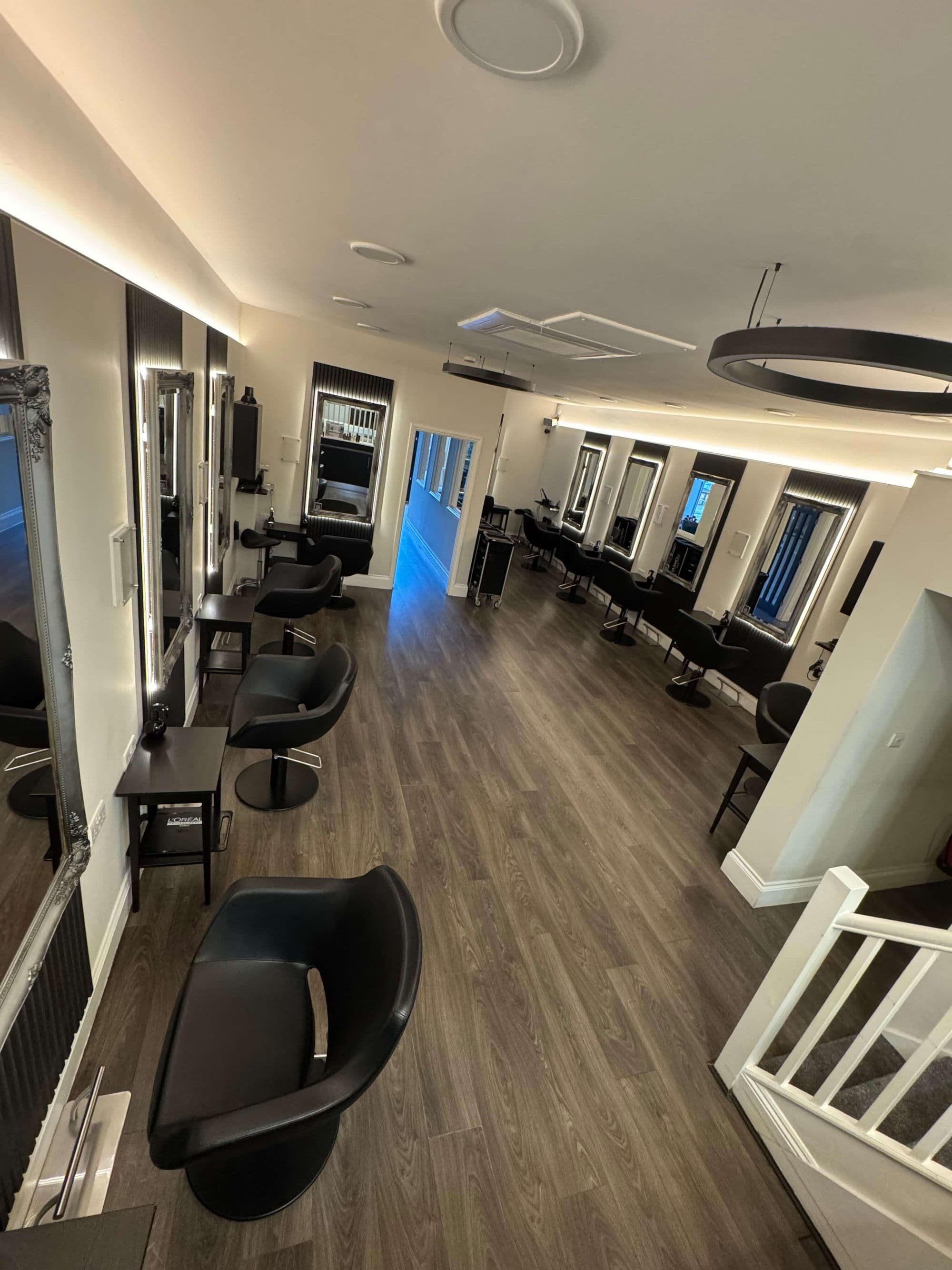 The Clay salon floor, a run of lit mirrors and leather chairs